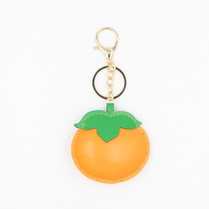 Detailed view of handmade orange persimmon faux leather keychain with golden metal clasp