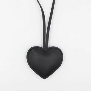 Minimalist black heart PU leather bag charm with neat stitching and long lanyard