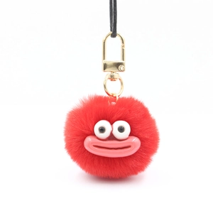 Red plush monster keychain with big eyes and gold metal clasp for bags and phone cases
