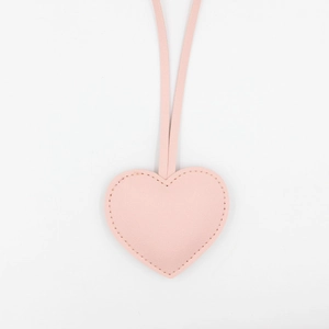 Pink heart-shaped PU leather bag charm with decorative stitching and hanging straps