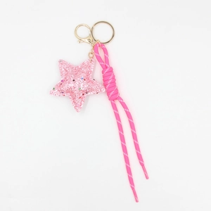 Pink glitter star keychain with woven rope strap and gold metal spring clasp