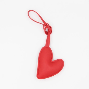 Detail view of red leather heart keychain with stitching and matching wrist strap