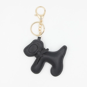 Porte-clés chien mignon en cuir PU noir avec fermoir mousqueton doré et petit nœud