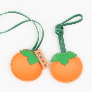 Detail of persimmon PU leather charms with litchi texture and lucky tag charms