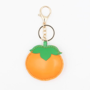 Handcrafted persimmon shaped PU leather keychain with gold lobster clasp and orange finish