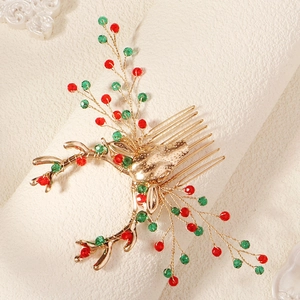 Detail of Christmas reindeer hair comb with red and green crystals on gold metal plating