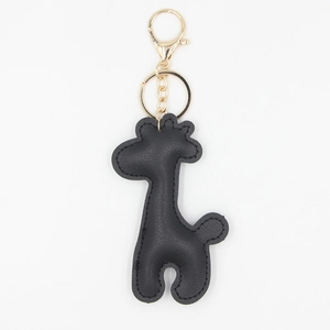 Detailed view of the black textured PU leather giraffe charm with gold hardware