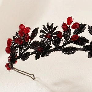 Detailed macro view of black gothic metal floral headband with red crystal beads