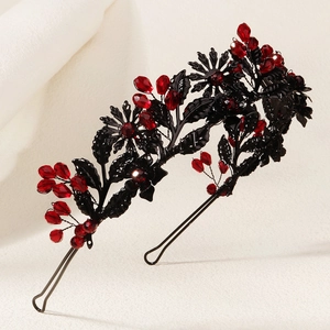 Close-up of handmade Gothic Halloween headband with black metal leaves and red crystals