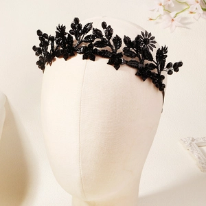 Close-up of gothic black floral headband with intricate crystal beadwork and leaf details