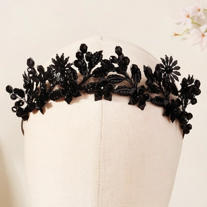 Detail of dark crystal beaded headband with black metal leaves and intricate handwork