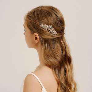 Exquisite gold bridal hair comb with cubic zirconia and rhinestones on wavy hair