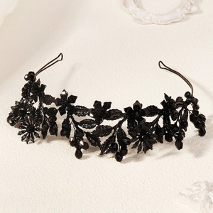 Close-up of black floral leaf gothic headband with intricate resin petals and crystal beads