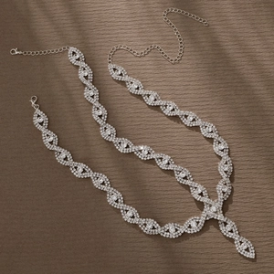 Detailed view of silver-toned rhinestone tassels with twisted braided design and lobster clasp