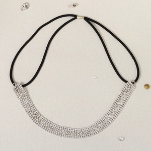 Détail d'un bandeau en strass étincelants avec cordon élastique sur fond texturé