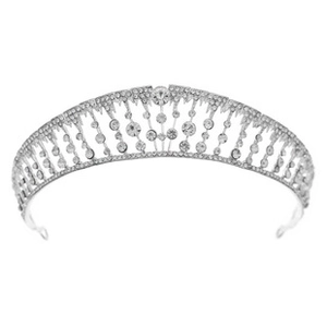 Detailed view of silver alloy tiara featuring intricate round rhinestones on white base