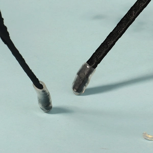 Detailed macro view of the black satin headband end featuring a soft protective silicone tip