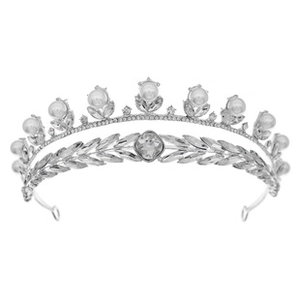 Detail of silver bridal tiara featuring large pearls and leaf-shaped crystals on an alloy frame