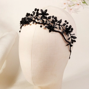 Detailed view of Gothic black floral leaf headband with crystals on a mannequin