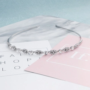 Detail of elegant silver headband featuring geometric patterns and sparkling zircons