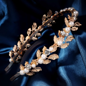 Golden bridal headband with metallic leaves, handmade pearls, and sparkling rhinestones