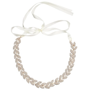 Detail view of crystal bridal leaf belt with white ribbon and sparkling rhinestones
