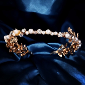 Golden bridal headband with handmade pearls and sparkling crystals on blue silk