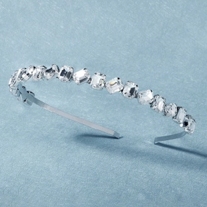 Close-up of sparkling rectangular zircon crystals on a silver leaf-style headband