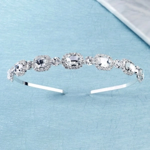Close-up of elegant silver hairband with large oval crystals and small round rhinestones