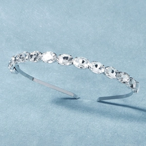 Detail shot of silver alloy headband featuring eleven sparkling oval crystal rhinestones