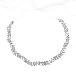 Close-up of silver crystal leaf belt with elegant white chiffon ribbon ties for wedding