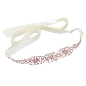 Close-up of pink crystal floral bridal belt with ivory satin ribbon for wedding dresses