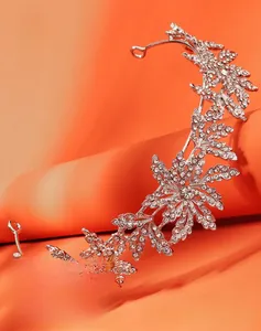 Close-up of silver bridal tiara with sparkling rhinestones and elegant leaf designs