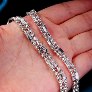 Macro detail of silver rhinestones with baguette and round cut stones for bridal belt