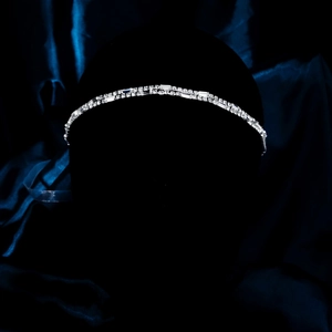 Close-up of elegant bridal headband with sparkling rhinestones on dark display
