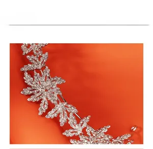 Close-up of bridal silver rhinestone crown with intricate leaf and floral vine patterns