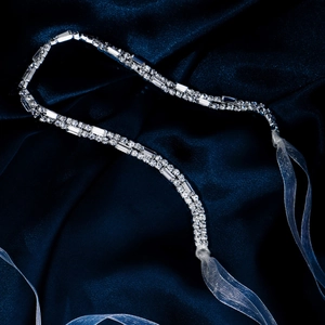 Detailed macro view of rhinestone headband with silver base and light blue ribbon ties