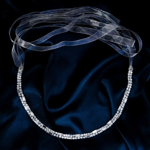 Detailed macro view of silver bridal sash with dual rows of crystal rhinestones and organza ribbon