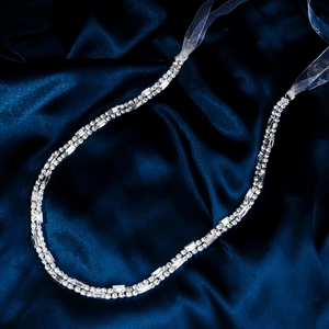 Close-up of elegant double-row rhinestone headband with silver base and ribbon tie