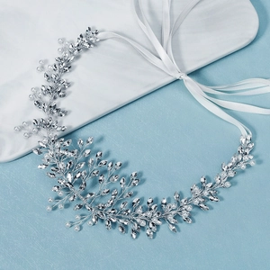 Detail of handmade bridal hair vine with marquise crystals, pearls and white ribbons