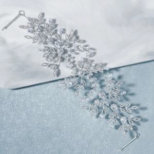 Detailed close-up of handmade silver bridal hair vine with crystal leaves and marquise stones