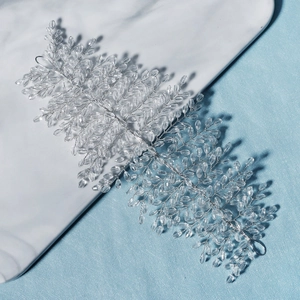 Detail view of handmade bridal hair vine with silver wire and faceted crystal leaves