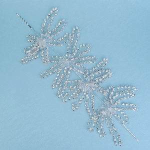 Detailed macro view of handmade crystal bridal headpiece with silver snowflake patterns
