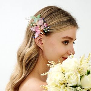 Romantic butterfly hair clip with colorful gauze wings worn by a model in a side view