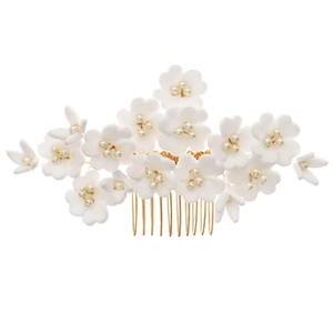 Detail of bridal hair comb with handmade clay flowers and decorative white pearls