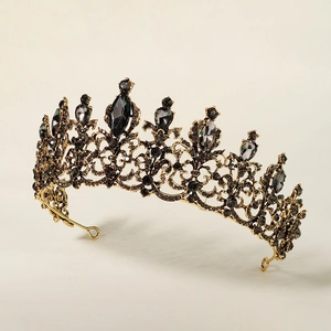 Detail of vintage bronze bridal crown with black crystals and intricate filigree patterns