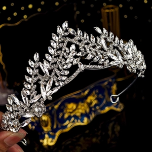 Close-up of crystal leaf tiara showing intricate silver alloy vine patterns and rhinestones