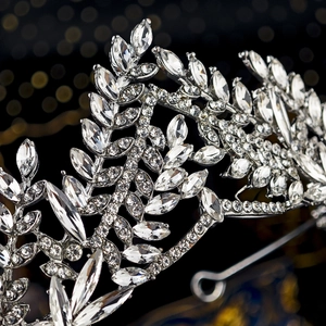 Macro shot of silver wedding crown with crystal leaves and faceted diamond details