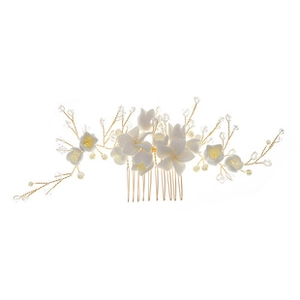 Detail of handmade bridal hair comb with white resin flowers and gold wire crystal accents