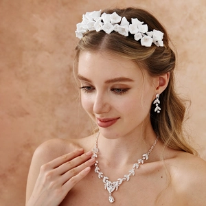 Close-up of elegant bridal headband with white flowers and matching jewelry set